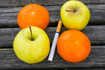 Fresh fruits close to the cigarette
