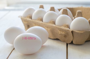 A group of fresh eggs with printed producers control serial number