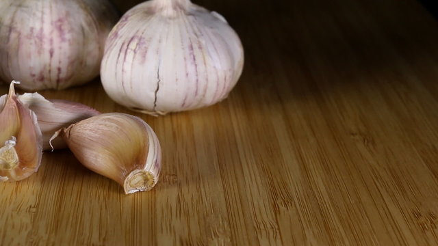 Organic garlic on wood chopping board. Macro shot.