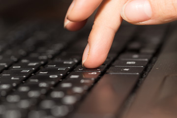 Fototapeta na wymiar finger on a laptop keyboard