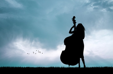 woman playing the cello at sunset © adrenalinapura