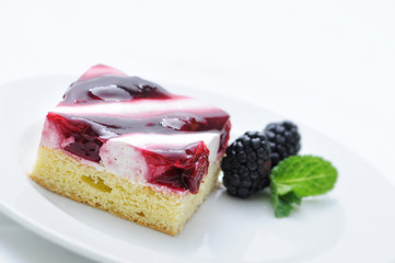 cream cake with fruit, gelatin and mint leaf on white plate, cake with blackberry, patisserie, sweet dessert, on-line shop photography