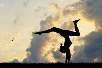 Girl does contortion at sunset