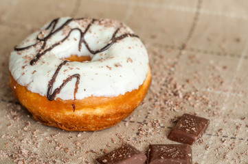 Donut with jam watered white chocolate. Dark chocolate, milk cho