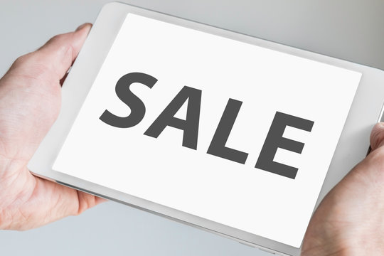 Sale text displayed on modern tablet as concept for online shopping and sales