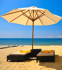 Beach umbrella and lounge chairs