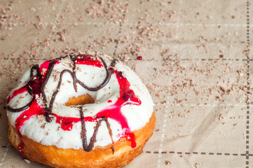Donut with jam watered white chocolate. Dark chocolate, milk cho