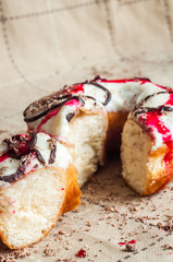 Donut with jam watered white chocolate. Dark chocolate, milk cho