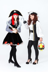 Fototapeta na wymiar Two young women in pirate costumes on white background