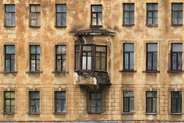Fototapeta na wymiar Many windows in row and bay window on facade of urban apartment building front view, St. Petersburg, Russia.