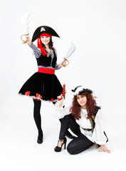 Fototapeta na wymiar Two young women in pirate costumes on white background