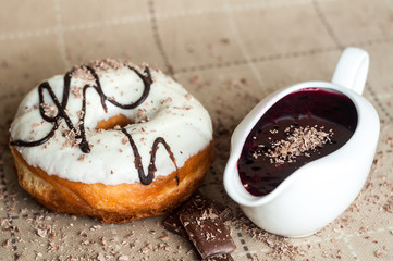 Donut with jam watered white chocolate. Dark chocolate, milk cho