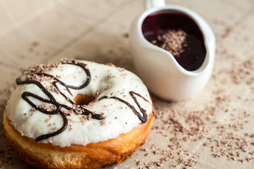 Donut with jam watered white chocolate. Dark chocolate, milk cho