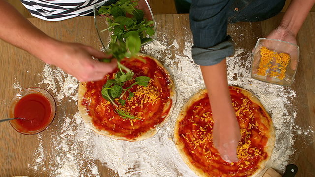 lose up view of a couple preparing pizza