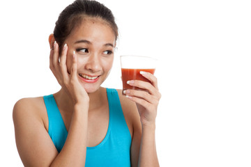 Beautiful healthy Asian girl like tomato juice