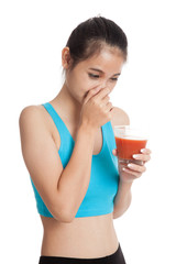 Beautiful healthy Asian girl hate  tomato juice