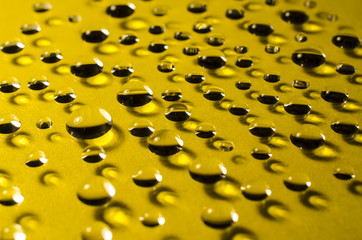 drops of water on yellow  background