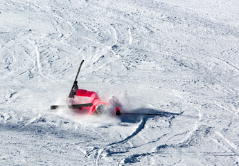 Woman riding on skis fall down