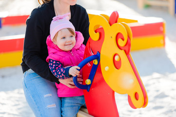 Little girl and her mother on the playground