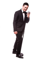 Fototapeta premium young man in suit singing with the microphone. Isolated on white background. Singer concept.