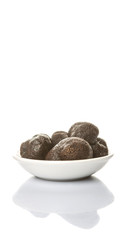 Black truffle mushroom in white bowl over white background