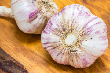 Organic garlic on wooden table background