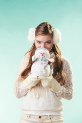 Cute woman with little snowman. Winter fashion.