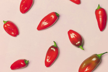Red Sweet Peppers on Pink Background