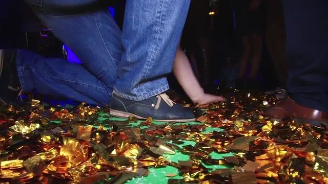 Beautiful dancing feet on gladness revelry party. Cheerful and energetic art music fun dancing in motion feet legs of group people human men and women female in a disco in shoes of different colors. 