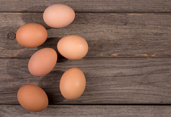 Group of Brown Eggs on a Rustic Wooden Surface