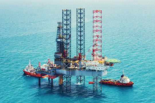 Image of oil platform while cloudless day,cross process tone.