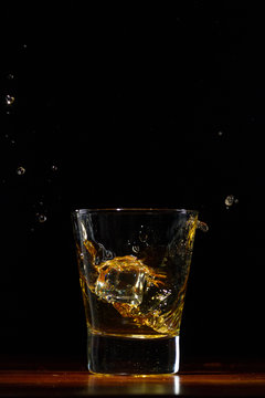 Whiskey Splash In Glass On Black