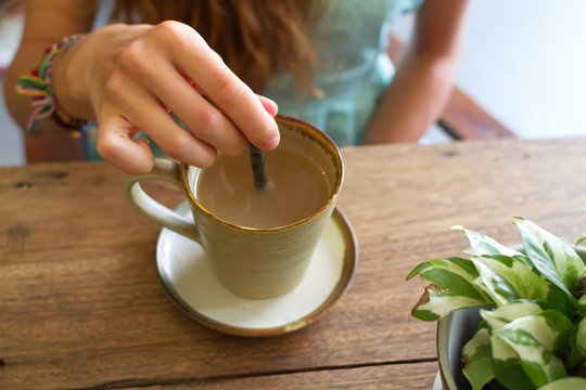 Cup of tea on a wooden table, a flower ы a pot on a table, tasty tea, fragrant tea, kiromichesky natural ware
