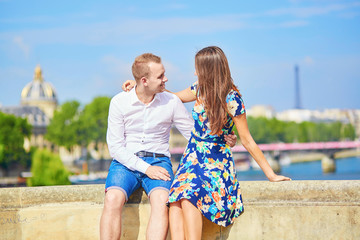 Fototapeta na wymiar Young romantic couple on the Seine embankment