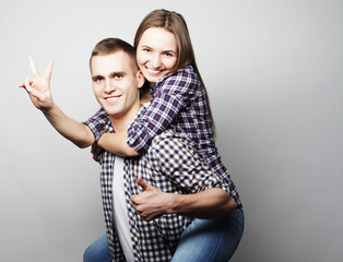 young man carrying girlfriend on his back.