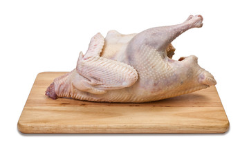 Raw chicken on a cutting board, isolated on white background