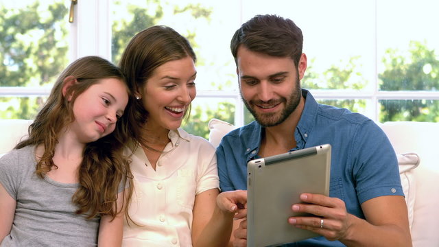 Family using tablet in living room