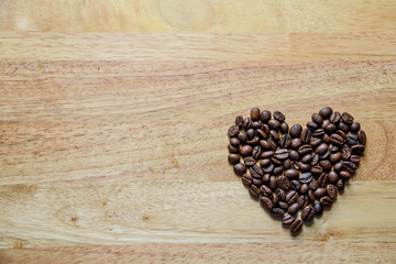 coffee beans in heart shape on wooden panel