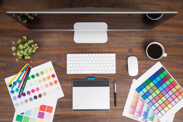 Top view of a creative graphic designer desk and workspace