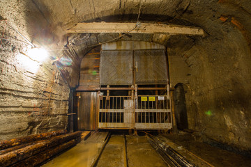Underground gold mine ore tuneel with rails cage Berezovsky mine Ural