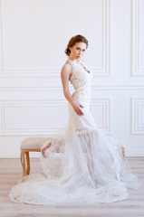 Young adult caucasian bride demonstrating a white bridal gown
