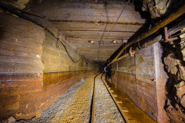 Underground abandoned gold mine ore tuneel with rails Berezovsky mine Ural