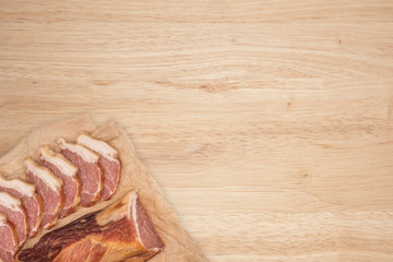 Smoked meat on a wooden table.