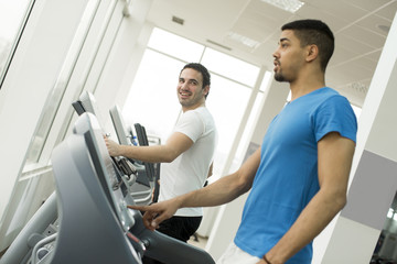 Fototapeta na wymiar Young multiracial men in the gym