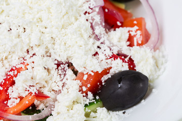 Fresh vegetable salad with grated cheese.