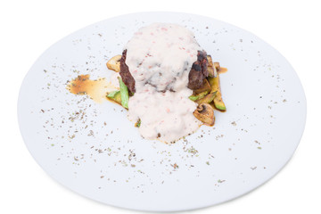 Grilled beef steak with vegetable garnish.