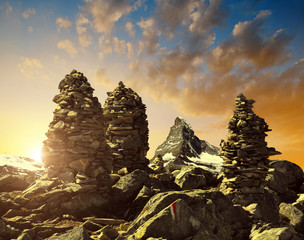 Stack of rocks stones at sunset in the background Matterhorn - Pennine Alps, Switzerland