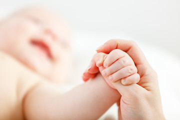 concept of parental love. baby hand holding  finger of mother