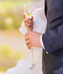 Bride and groom with champagne glasses in wedding day