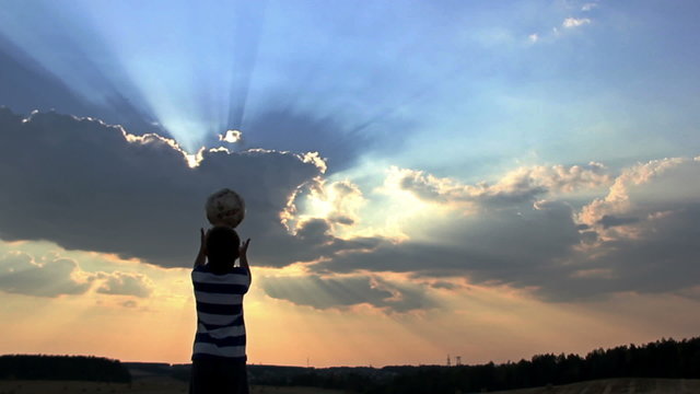 Boy Dreams Of Becoming A Soccer Player, Boy Playing With A Ball At Sunset